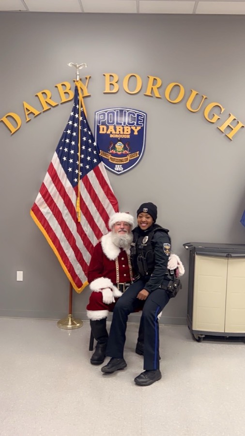Santa sharing a photo with a Darby Borough police officer